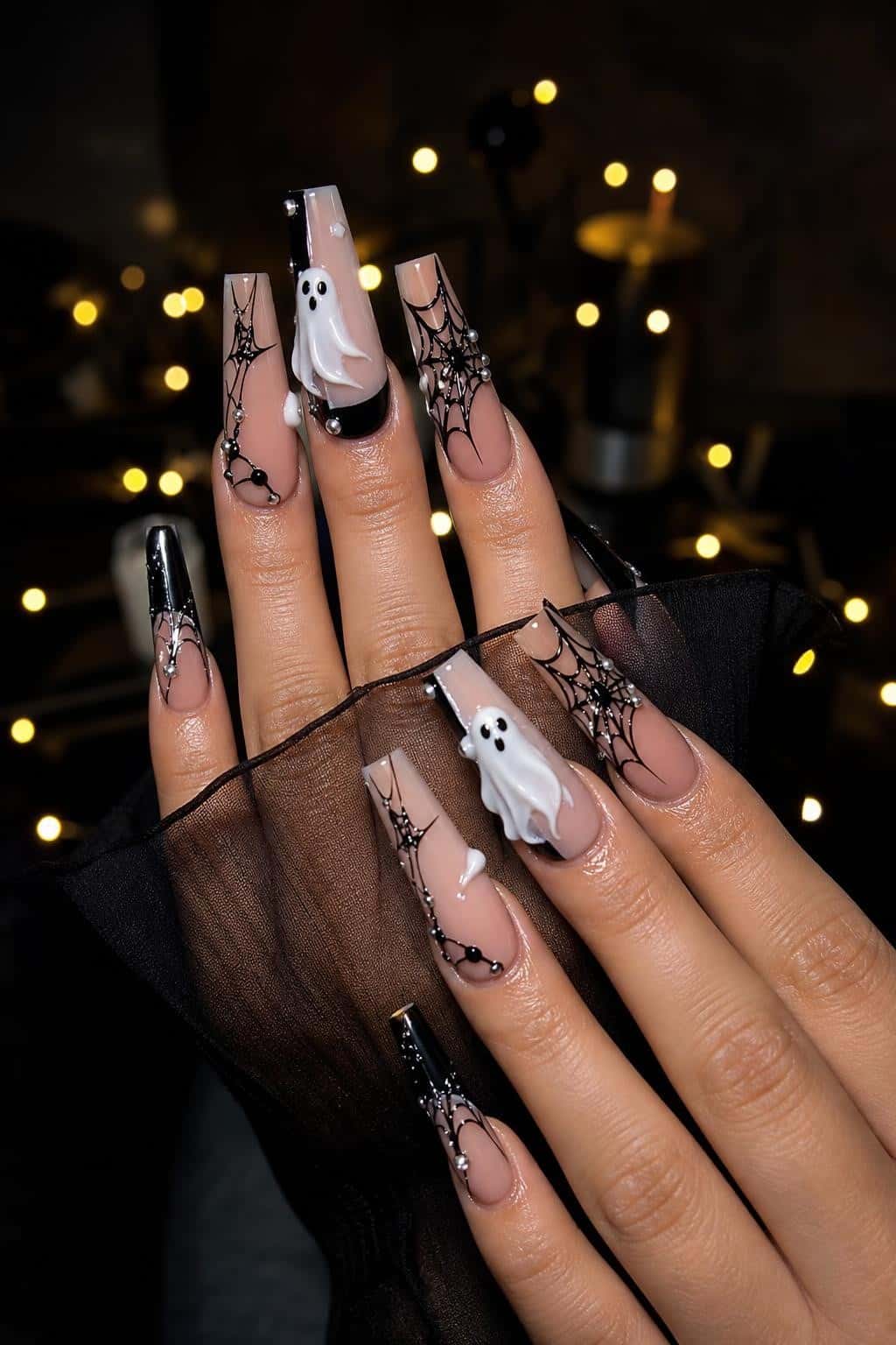 Long chrome and metallic stiletto nails with glitter ombre effect and rhinestones.