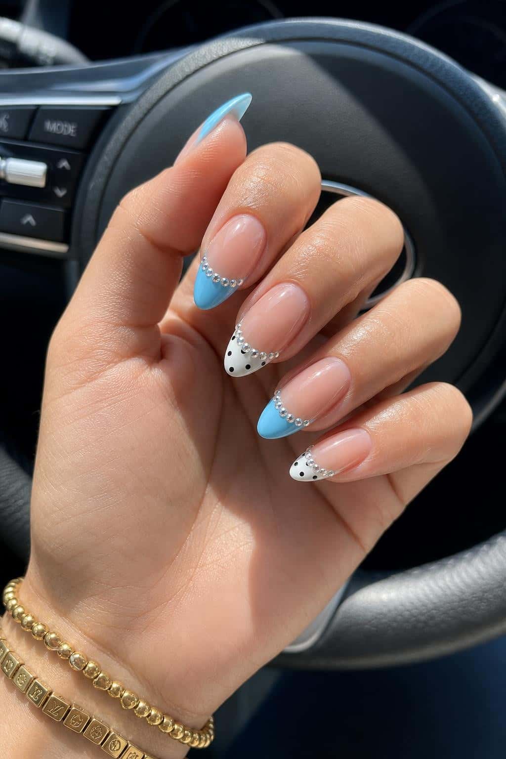 Long blue glitter stiletto nails with holographic shimmer and ombre tips.