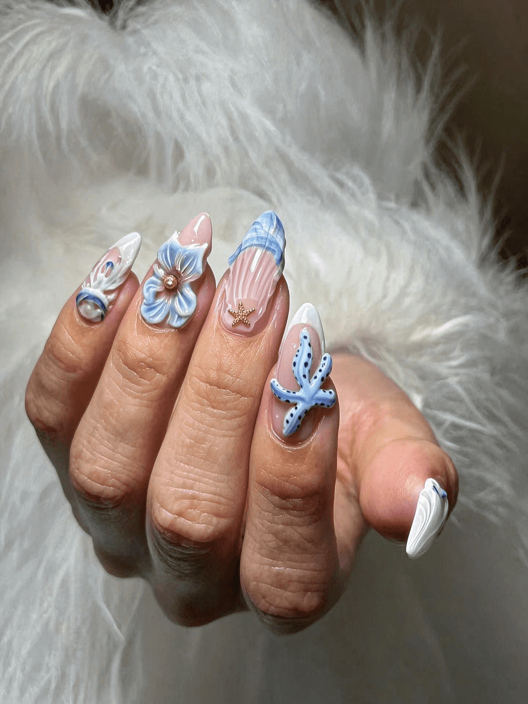 Long blue glitter stiletto nails with holographic shimmer and ombre tips.
