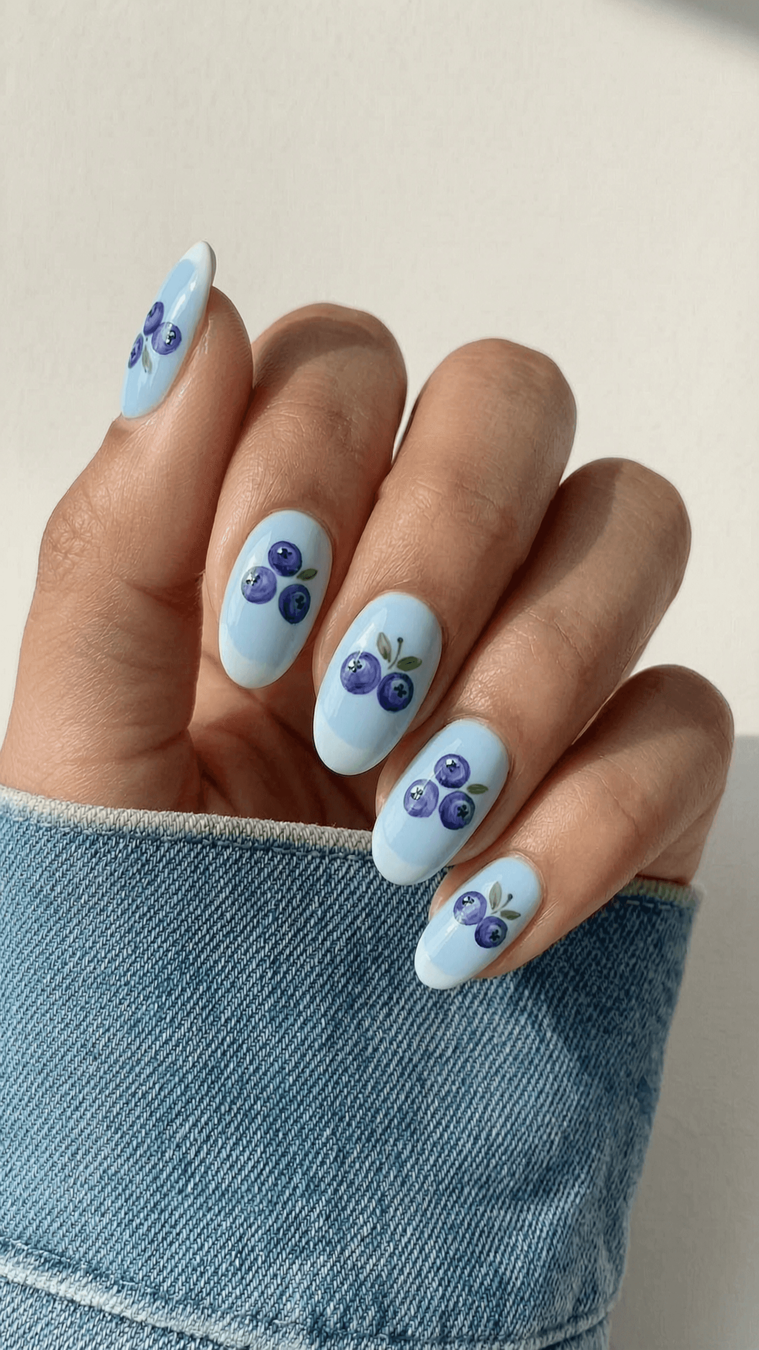 Long blue glitter stiletto nails with holographic shimmer and ombre tips.