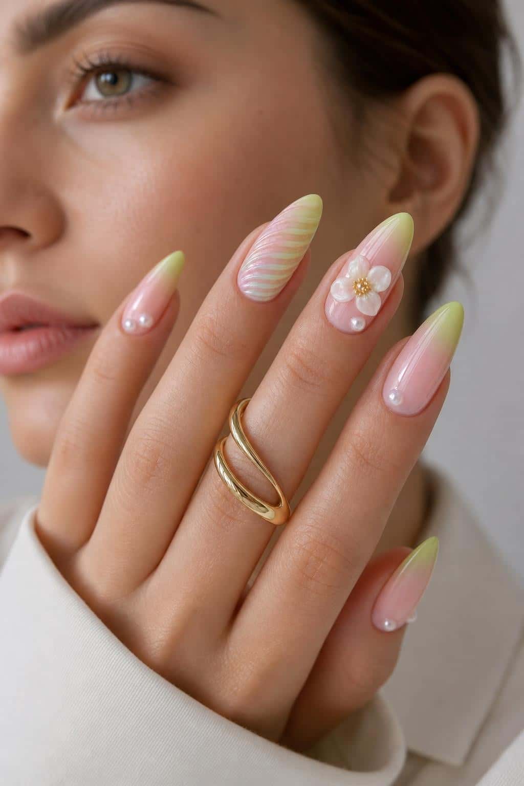 Long pastel floral stiletto nails with iridescent shimmer and glossy finish.