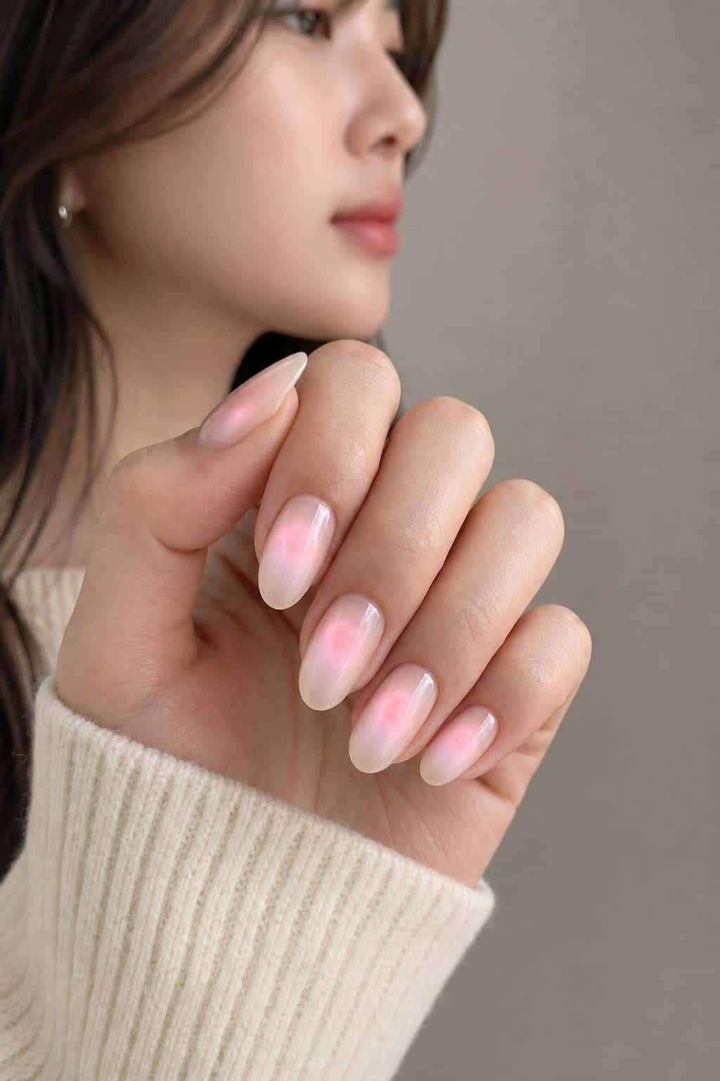 Long pink aura almond nails with sheer gradient finish.