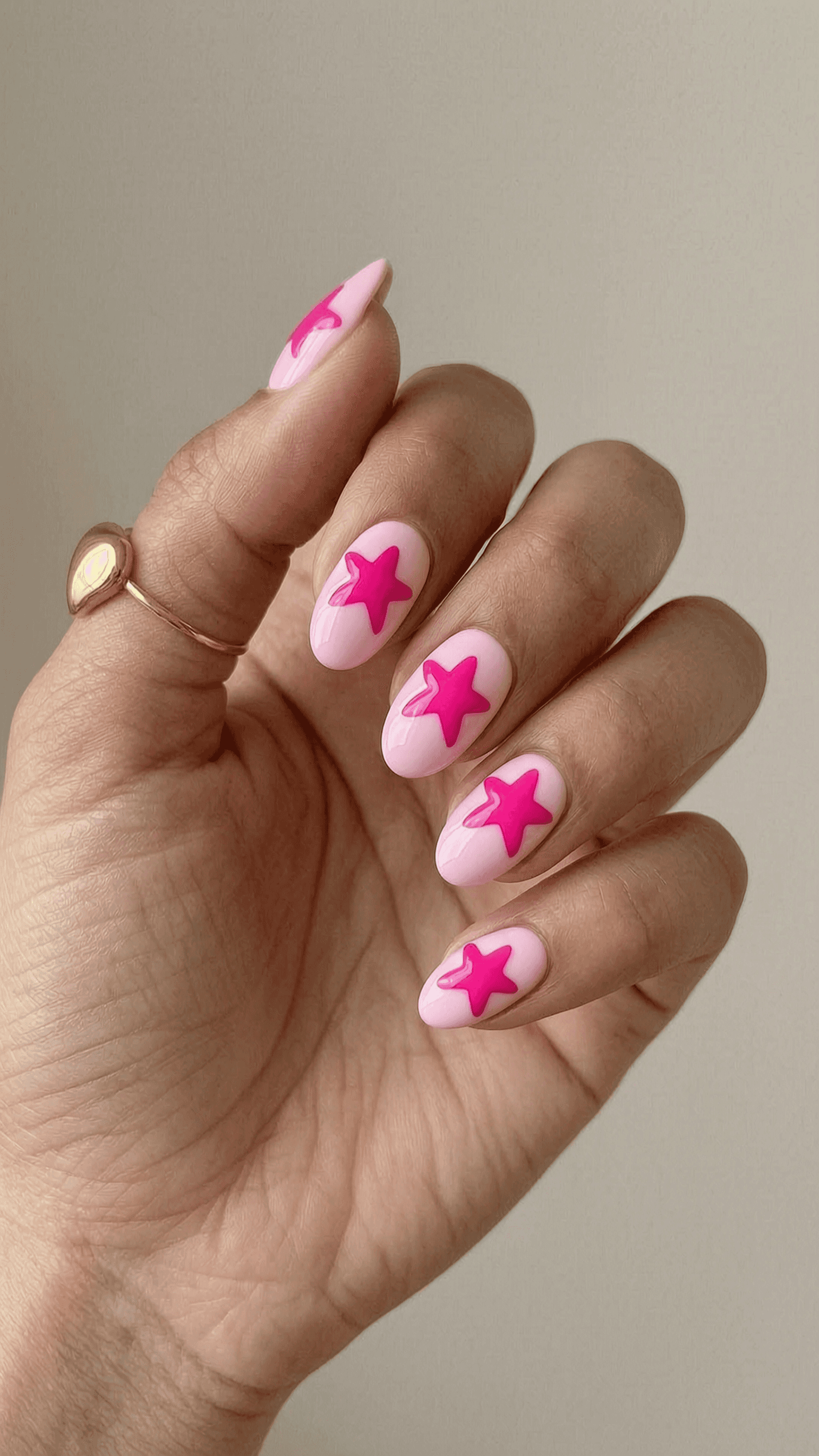 Long pink and fuchsia star stiletto nails with glossy finish and playful micro-shimmer.