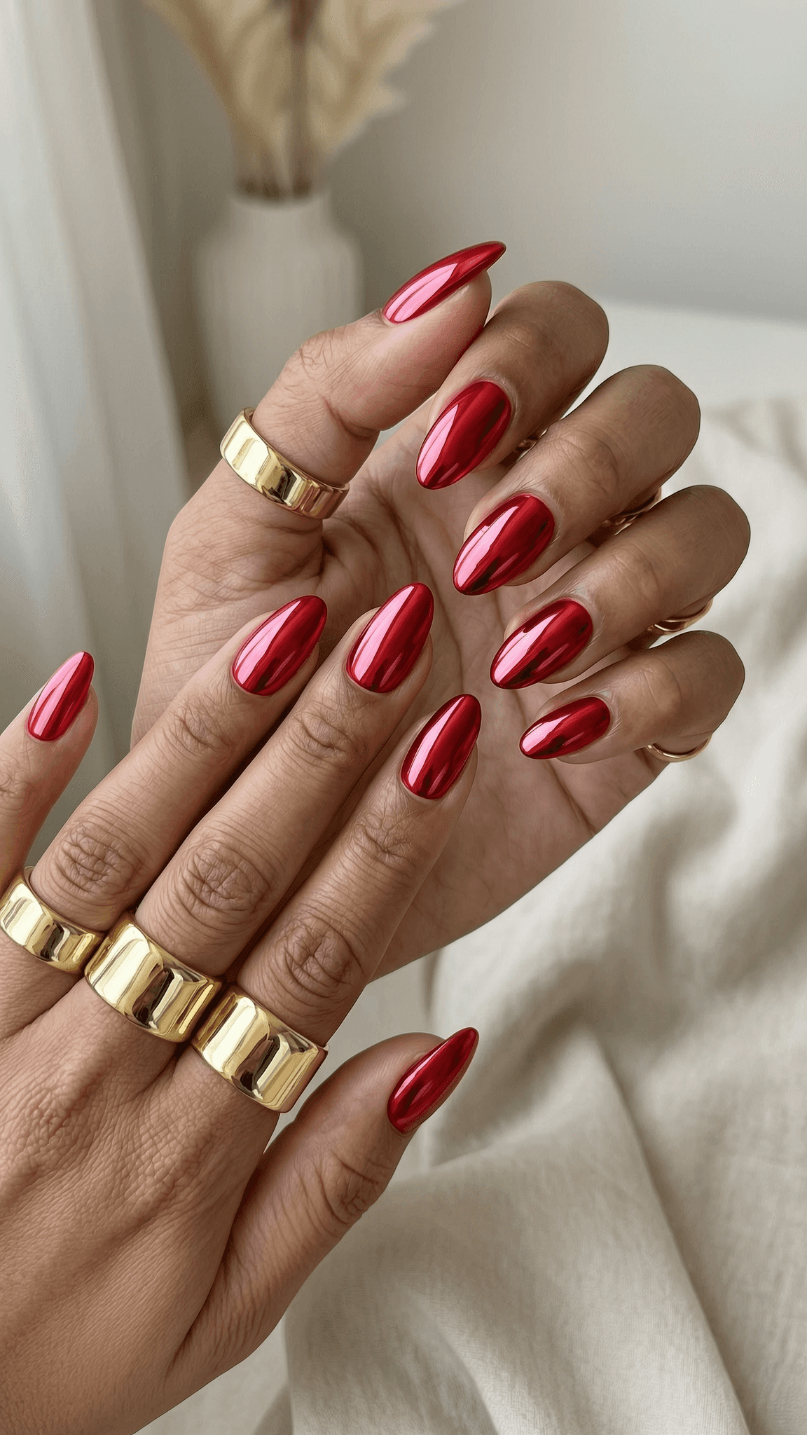 Almond nails with a vibrant, high-gloss red chrome finish.