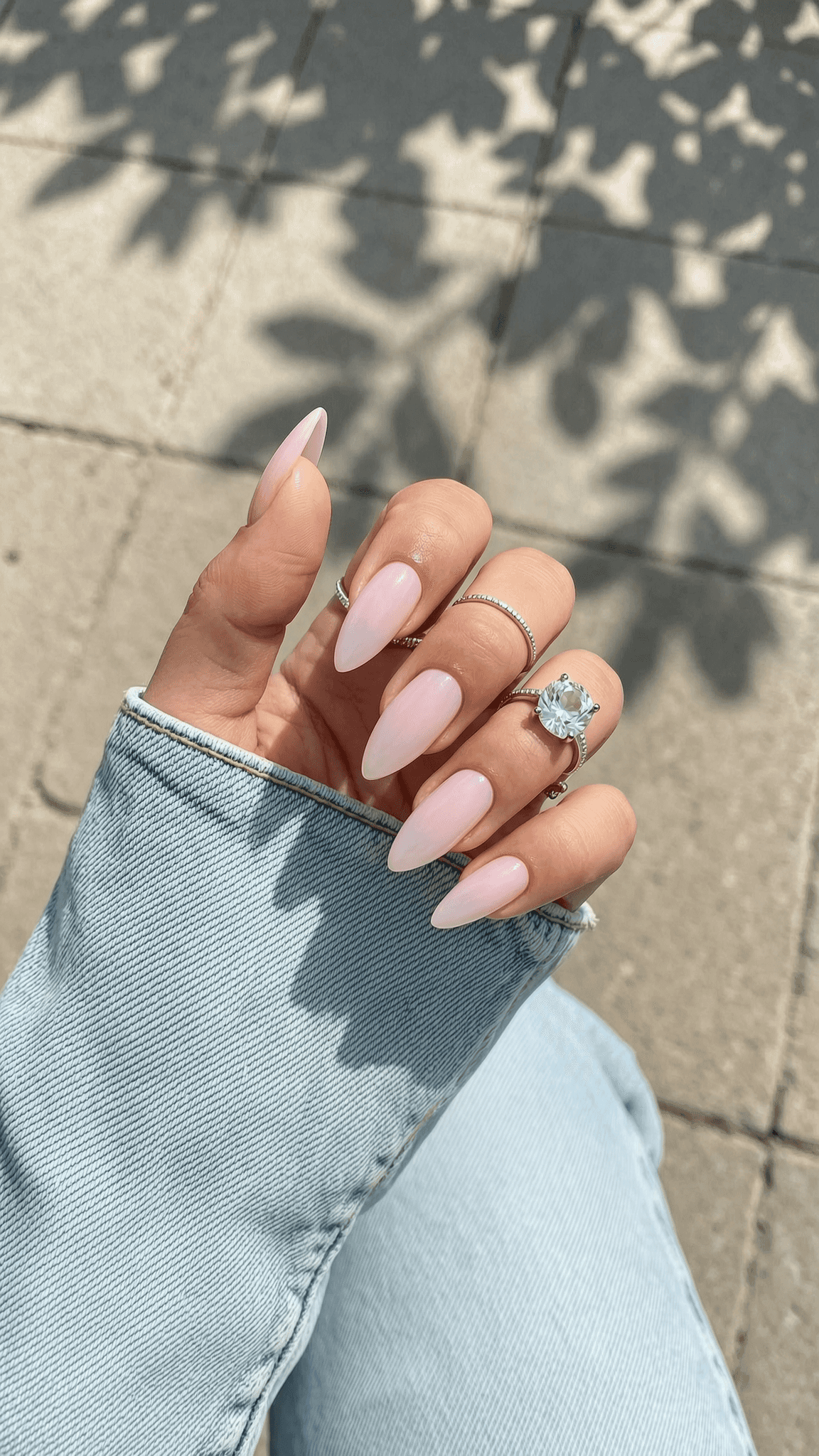 Long stiletto nails with a sheer, milky pink glossy finish.