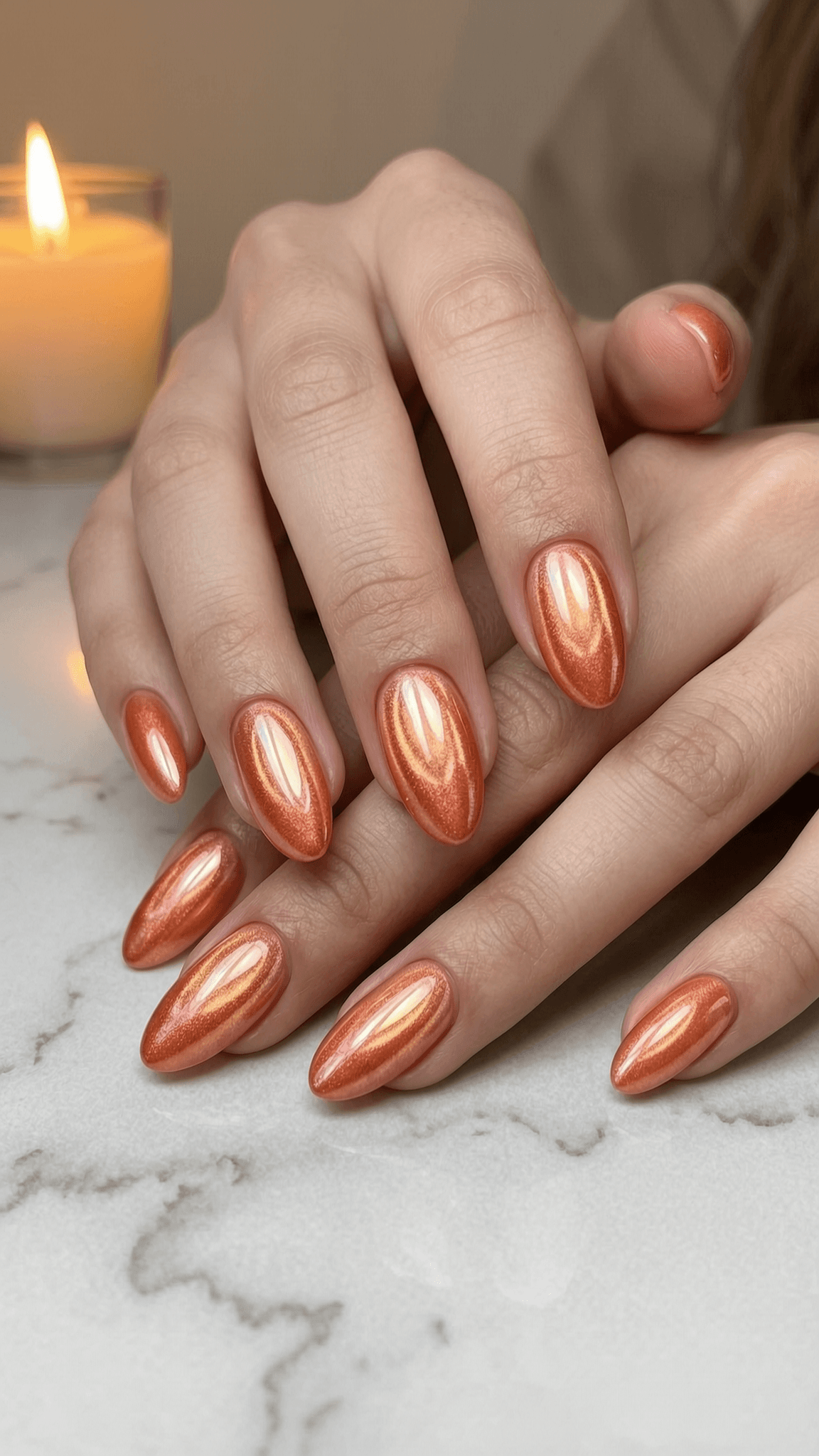 Copper cat eye nails with a magnetic shimmer line across almond tips