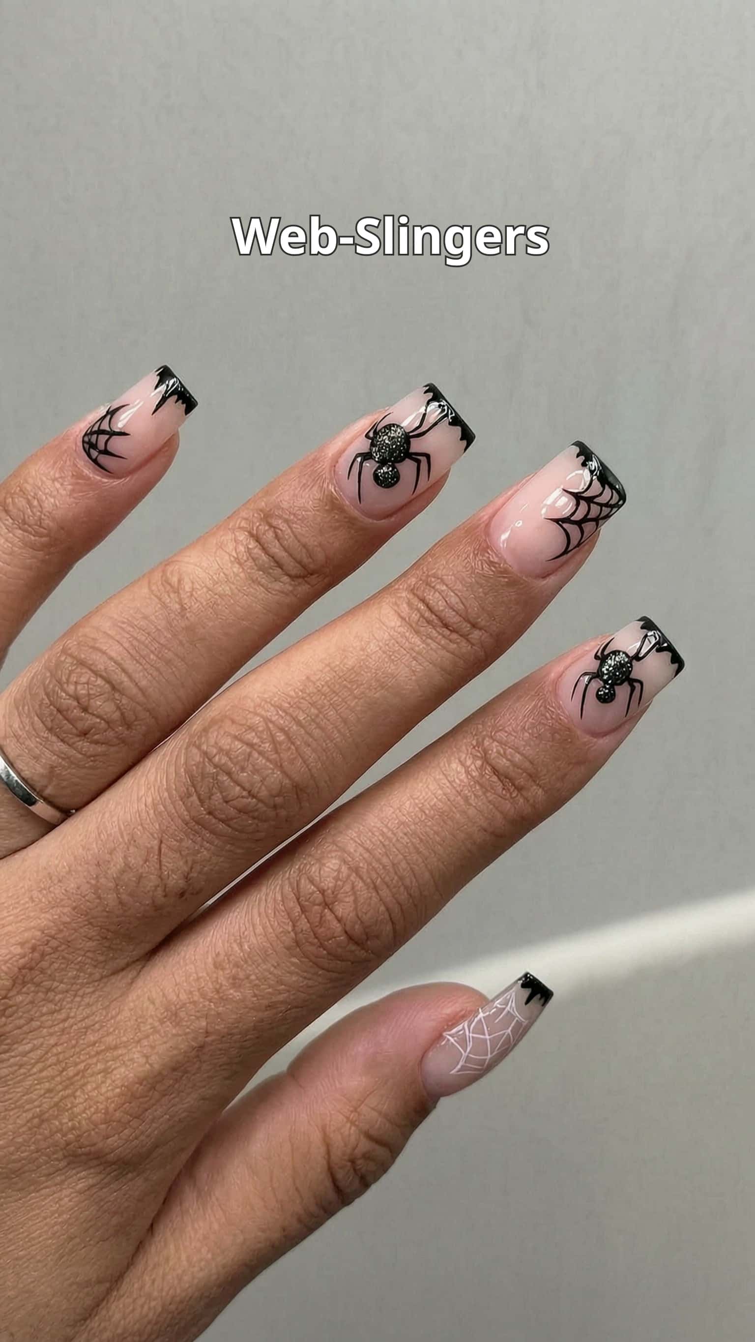 5 halloween nail ideas on manicured hands, including creepy clowns, haunted kitty, friendly ghosts, bats.