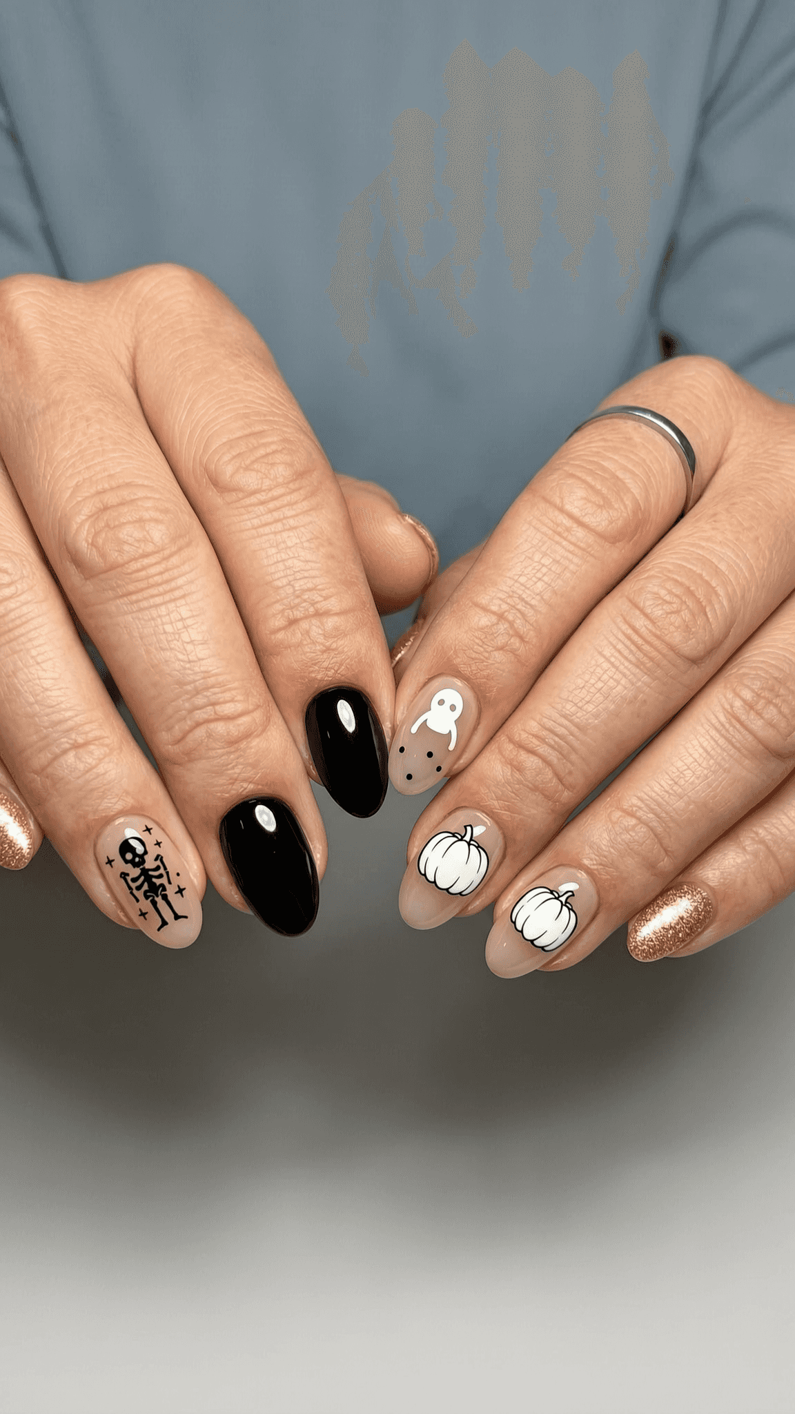 9 halloween nail ideas on manicured hands, tagged halloween nails, spooky nails, nail inspo.