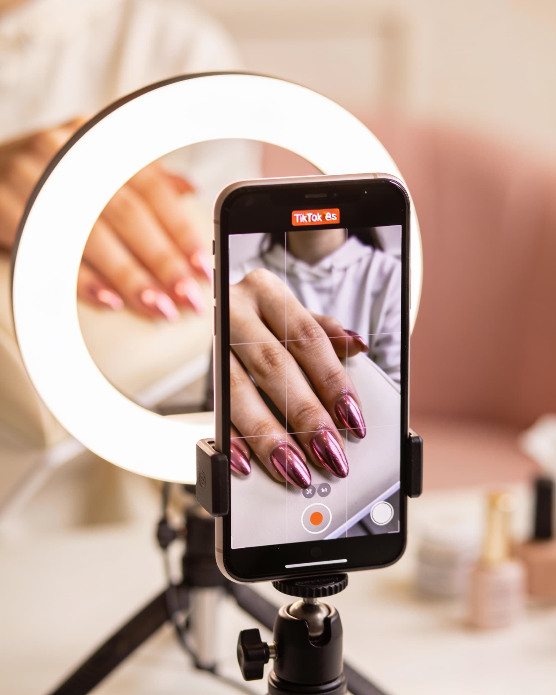Creator filming an AI-style nail video for TikTok and Instagram Reels