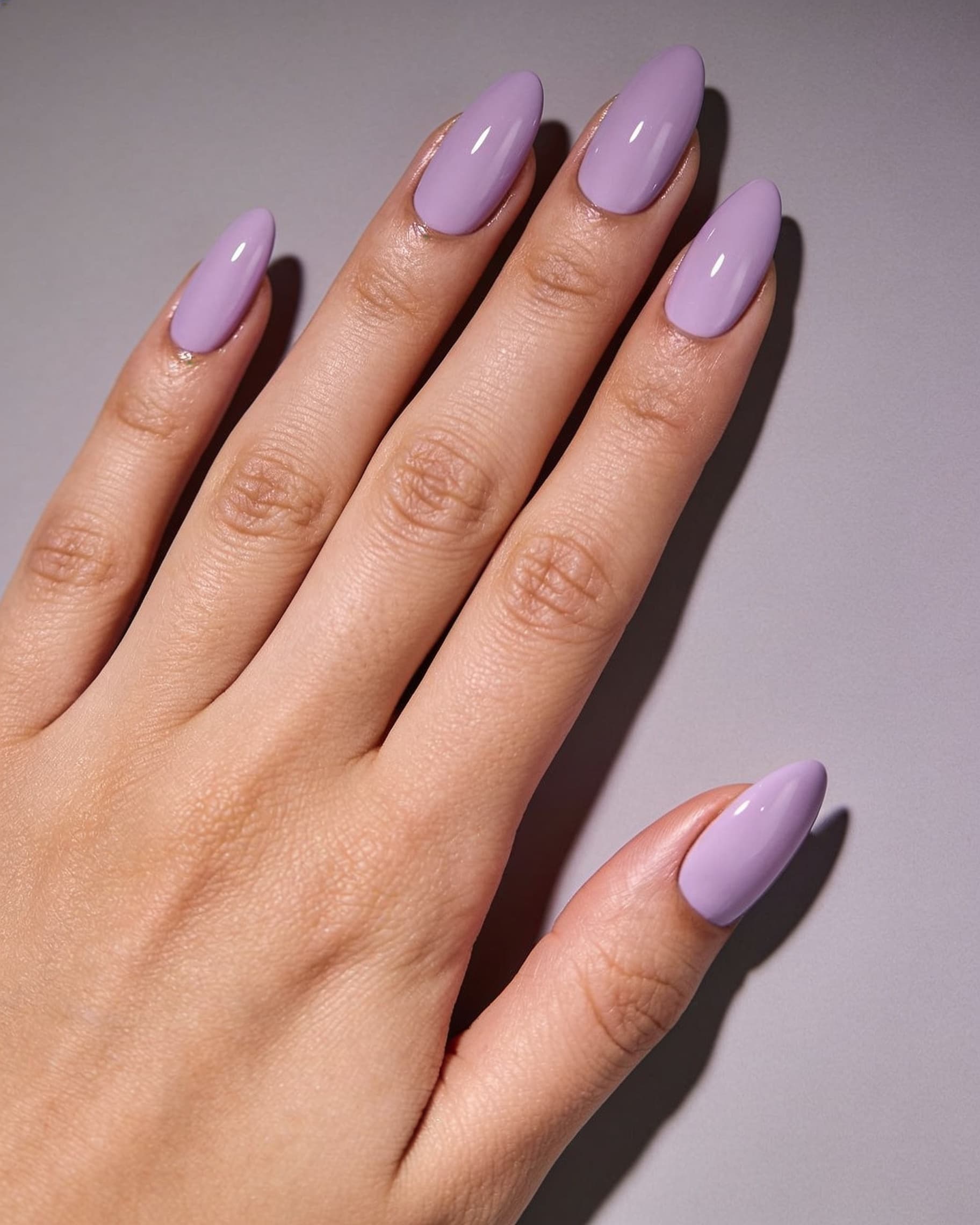 Lavender haze manicure preview: soft lilac nails on cool gray backdrop, NailMock