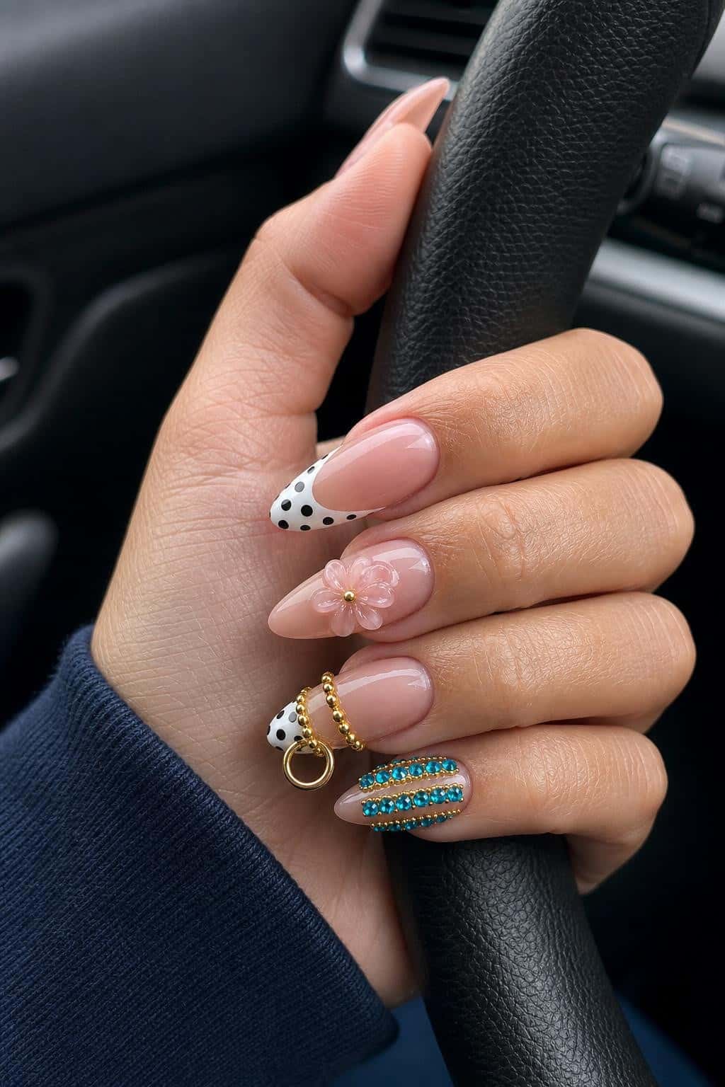 French tip nails with 3D flower accents and rhinestones in gold.
