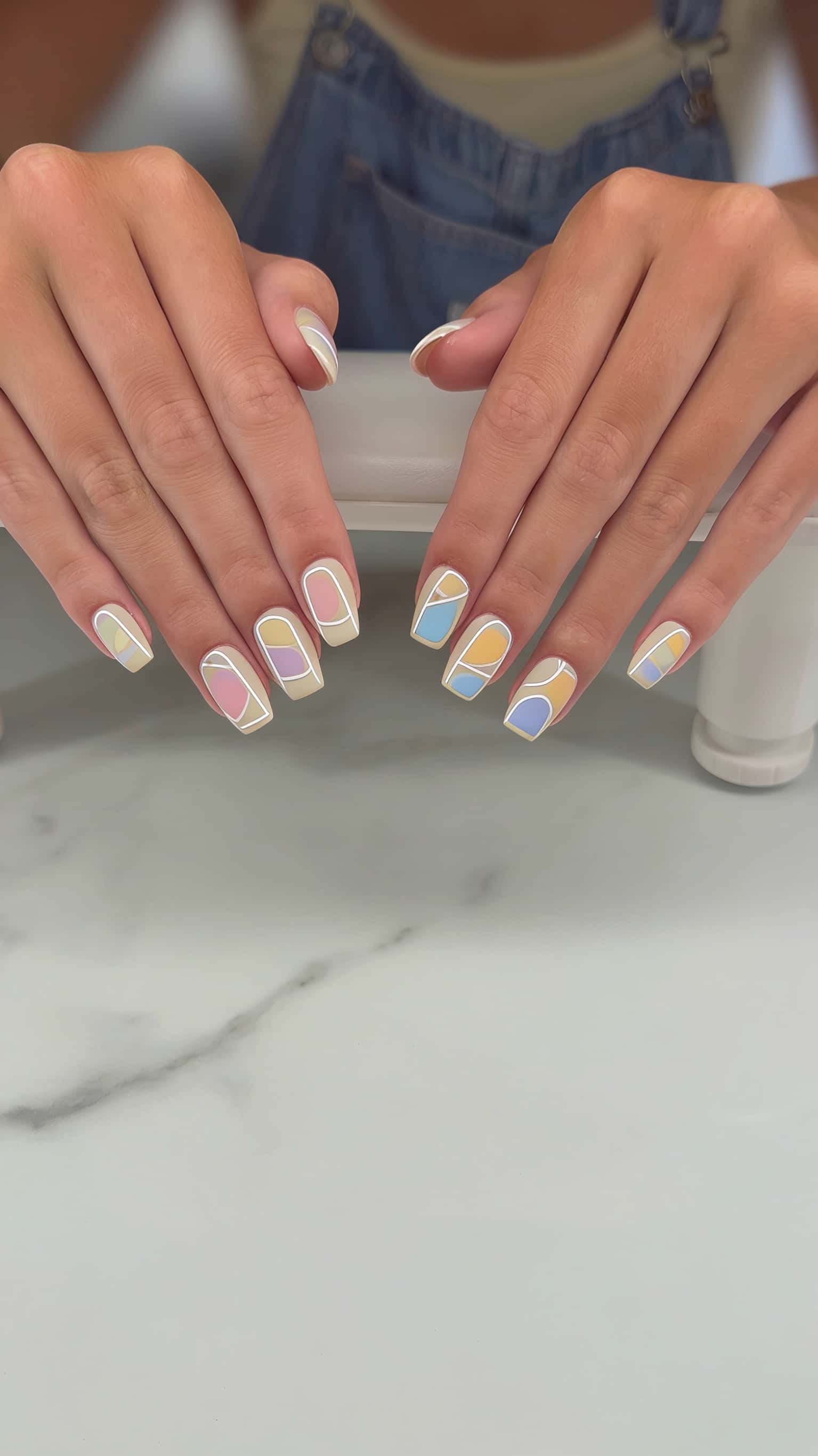 Long blue glitter stiletto nails with holographic shimmer and ombre tips.