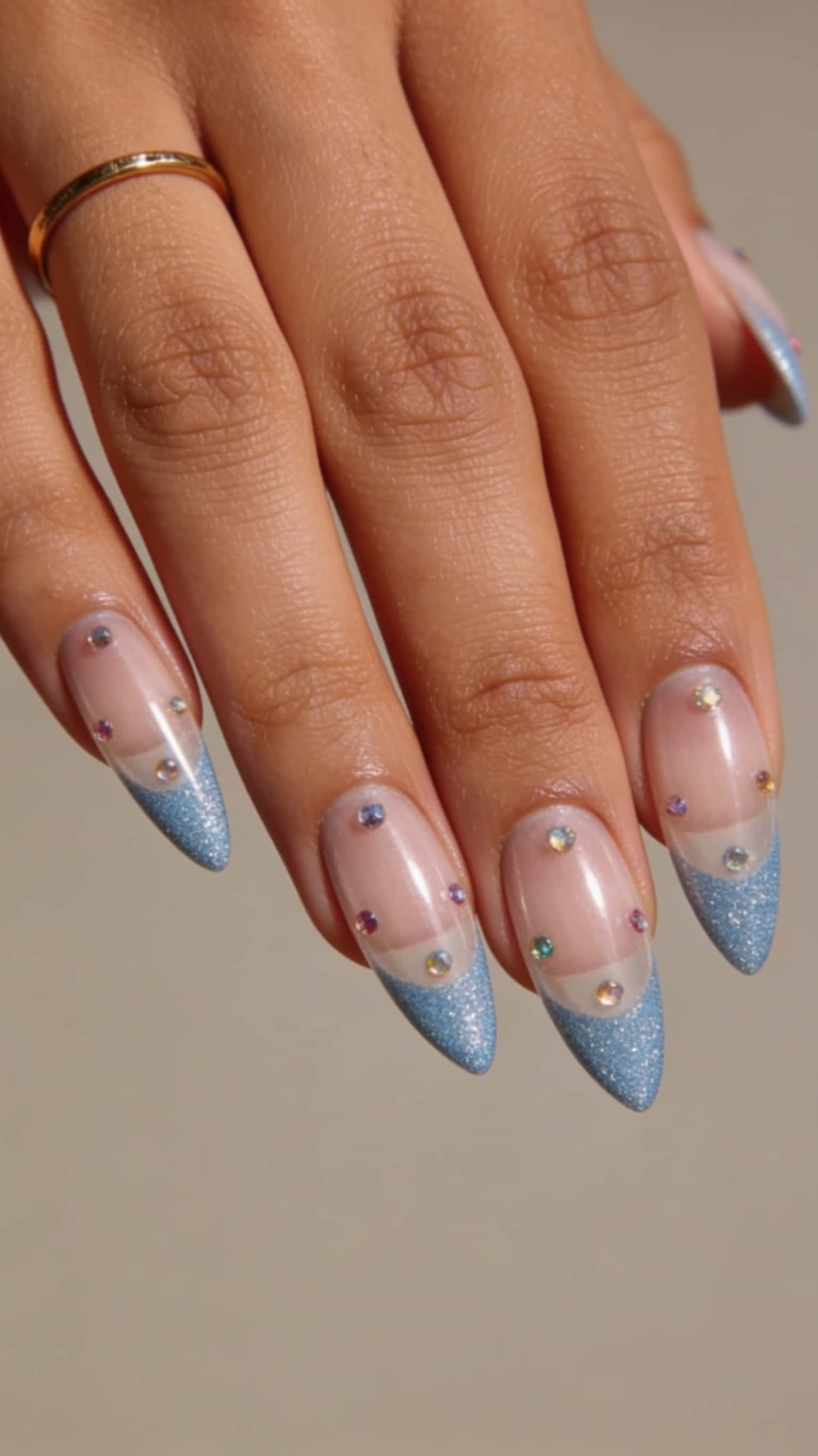 Long blue glitter stiletto nails with holographic shimmer and ombre tips.