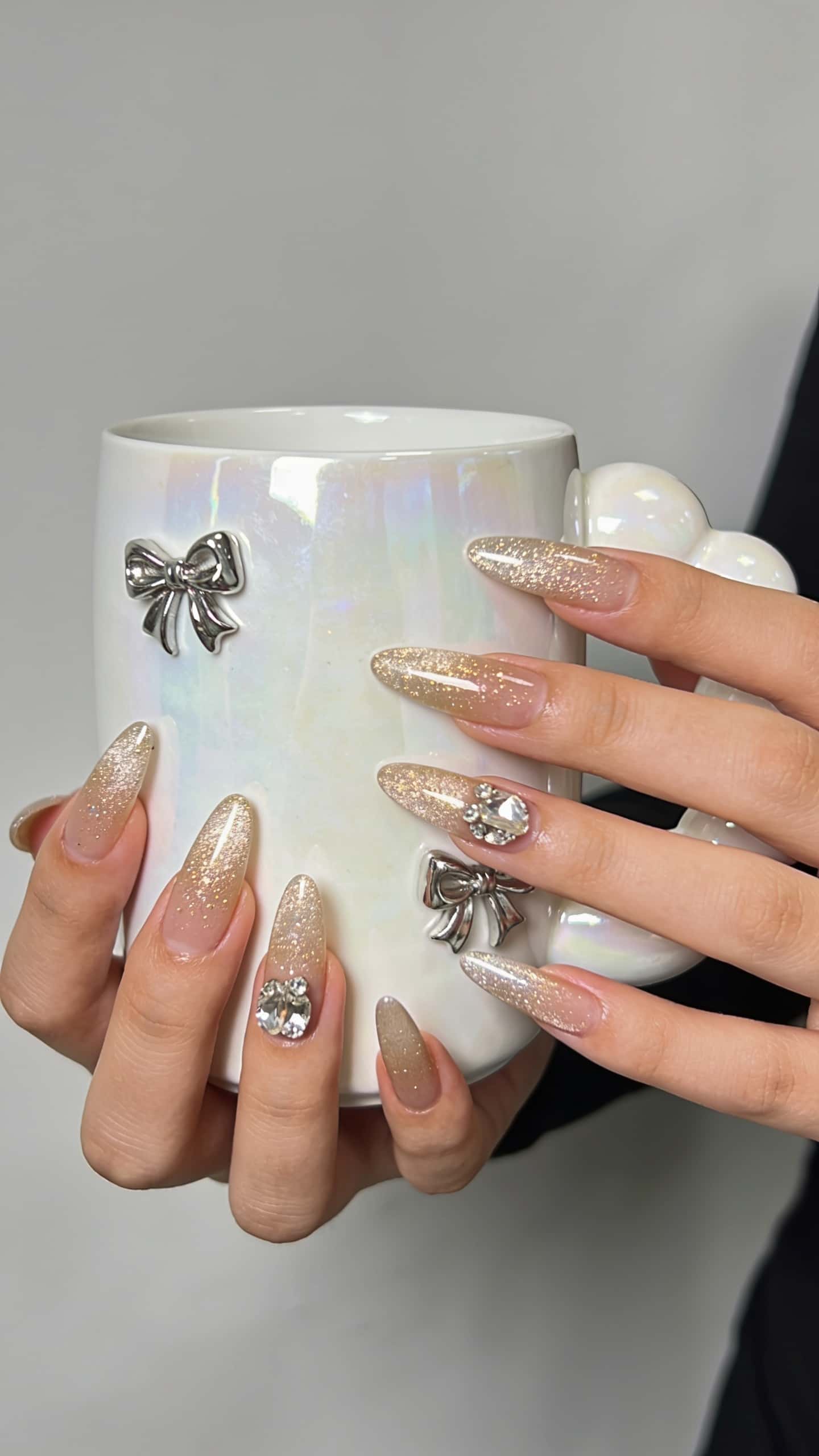 Long blue glitter stiletto nails with holographic shimmer and ombre tips.