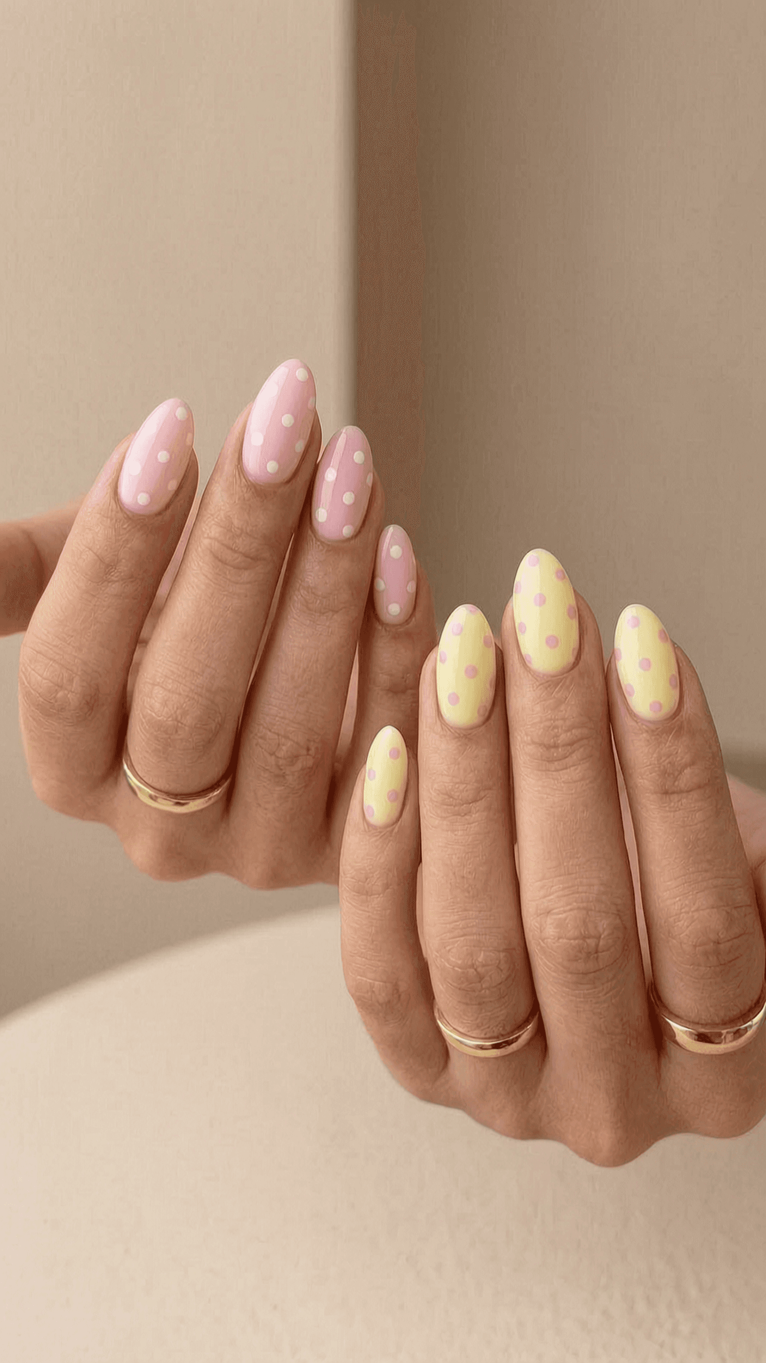 Almond nails with a playful mixed pastel pink and yellow polka dot design.