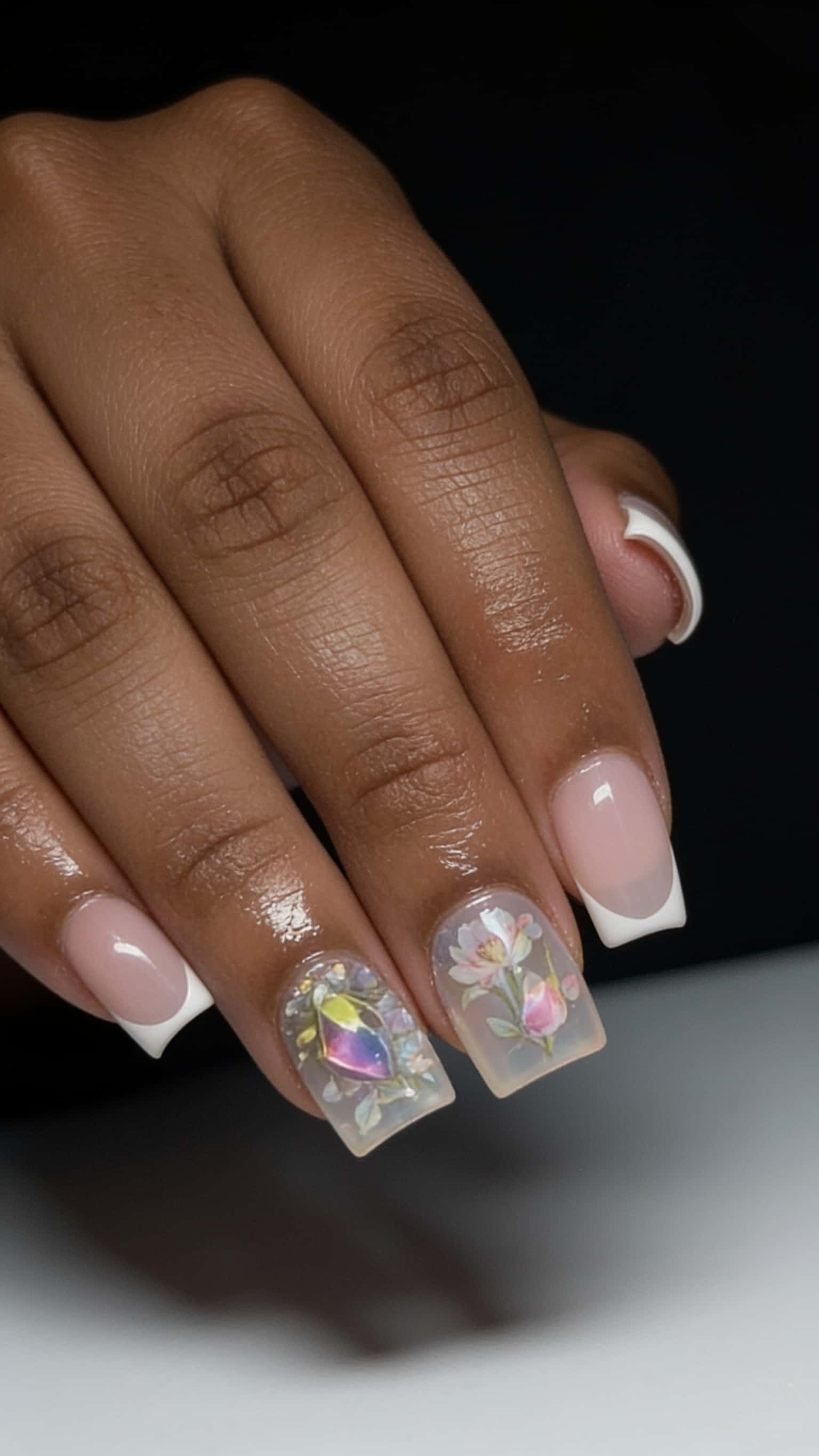 Square-shaped nails with pastel floral French tip design and gem accents.