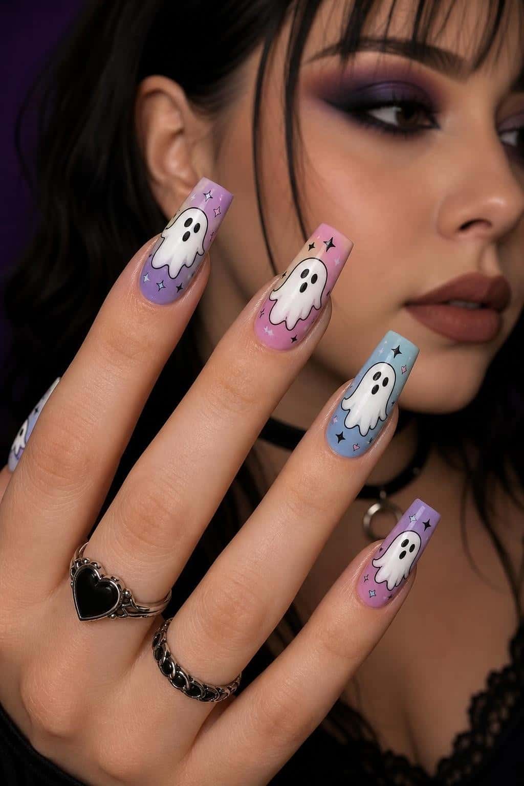 Long coffin nails with pastel ombre bases, featuring cute white ghost illustrations and black outlined stars.