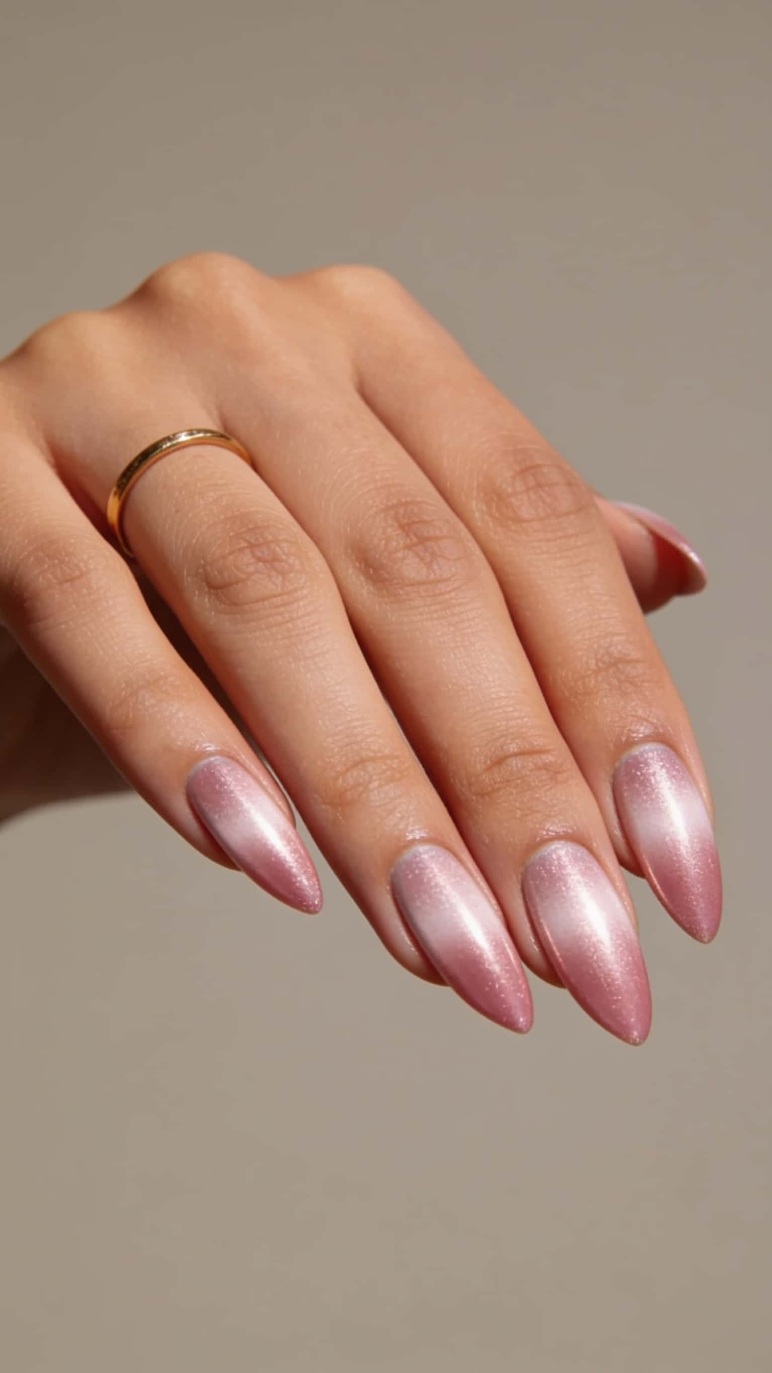 Pink ombre almond nails with cat eye design and shimmer.