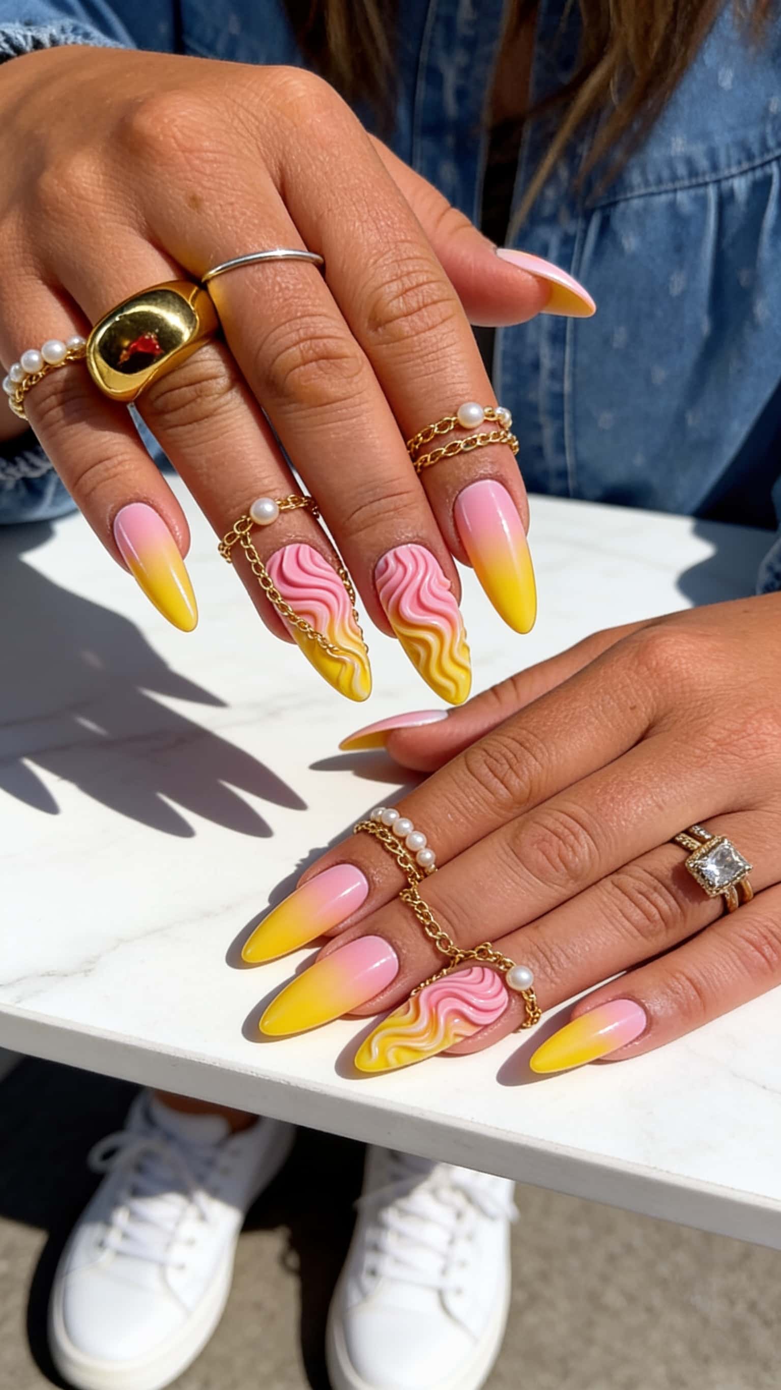 Long stiletto nails with pink swirl ombre and 3D wavy swirl pattern.