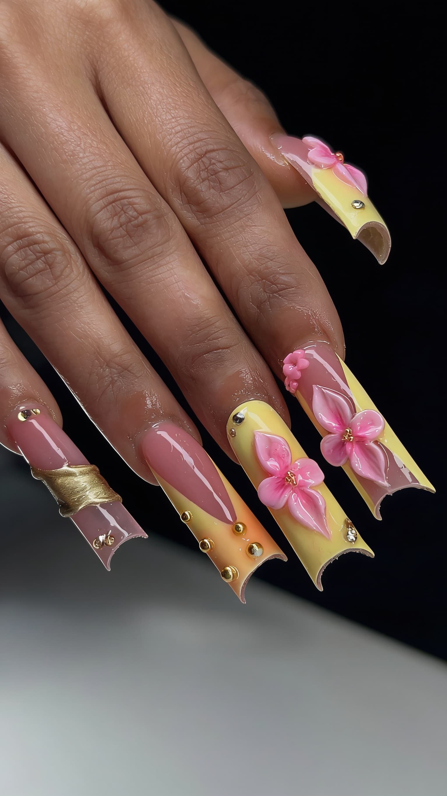 Sunset Floral Glam nail inspo: warm coral and gold floral nail art on long nails from the NailMock gallery